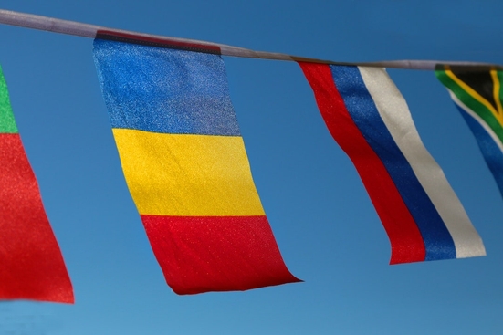 A series of international flags hung on a banner
